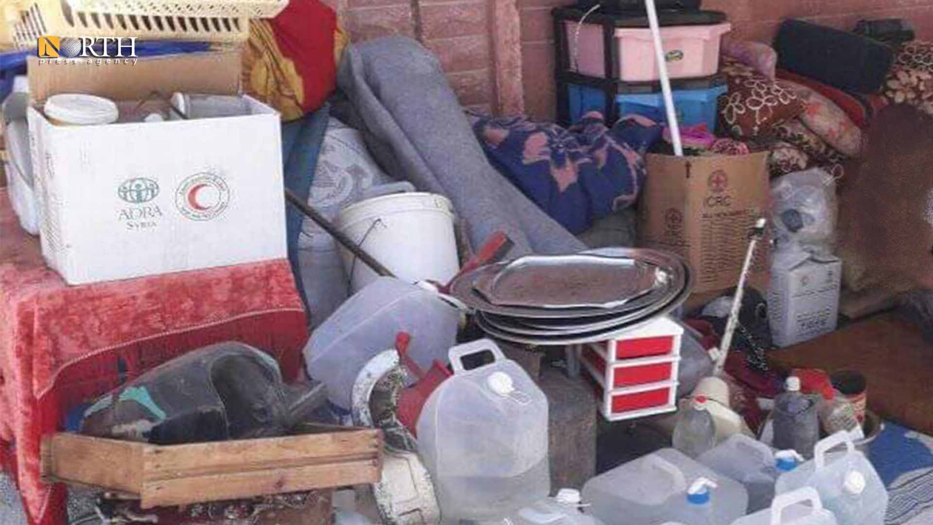 Possessions of a displaced family on a sidewalk in the city of Hama after their failure in renting a house
