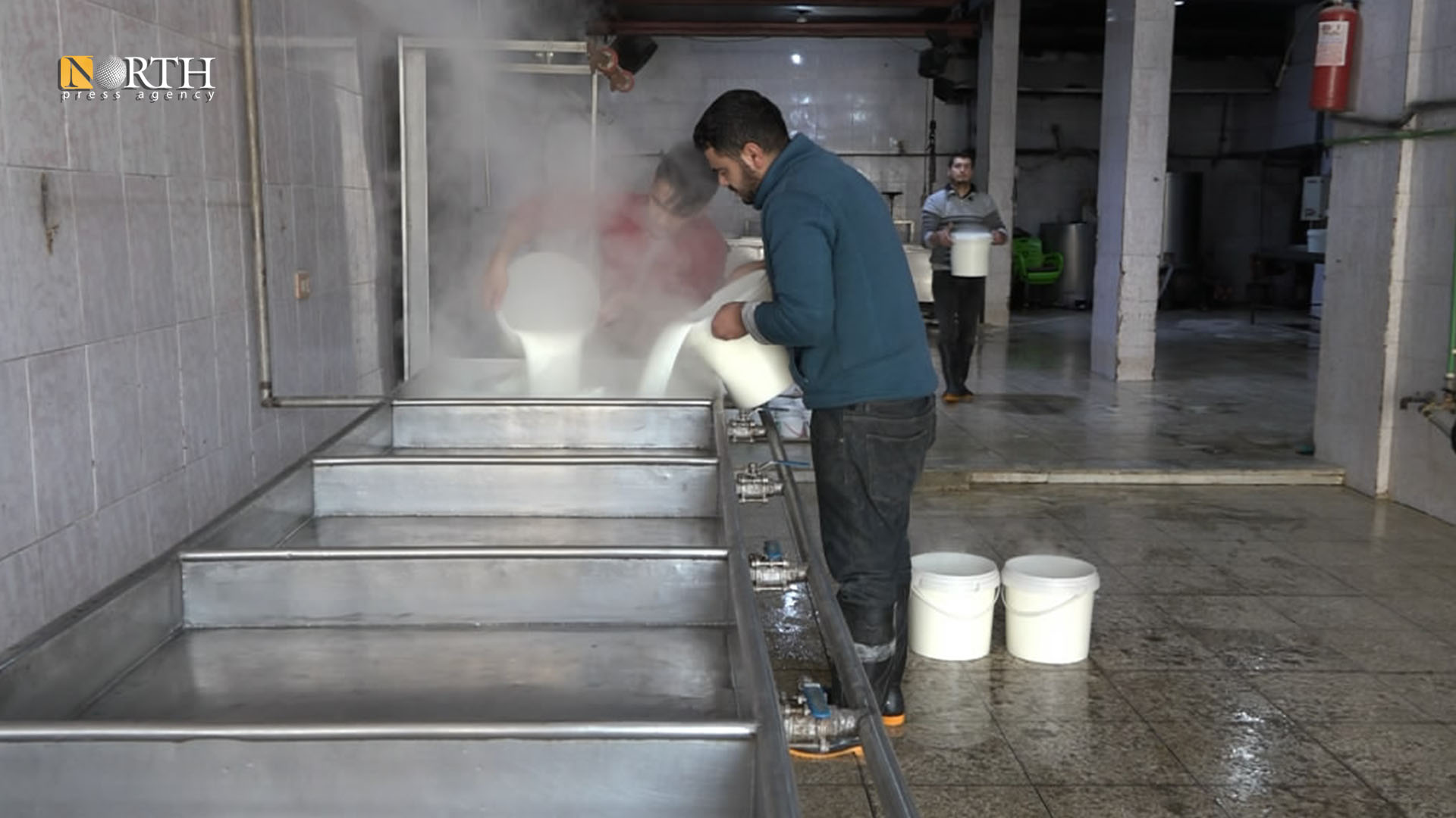 A worker prepares milk to manufacture it in the yogurt facility in Manbij – North Press