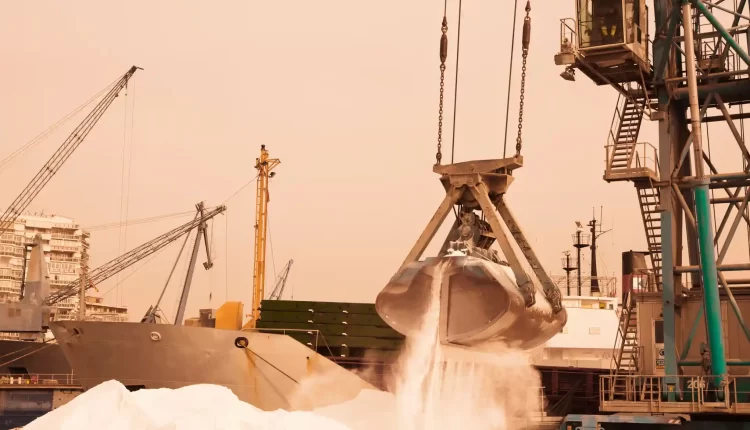 A harbor crane lifting phosphates into a ship. Photograph: Design Pics Inc/Alamy