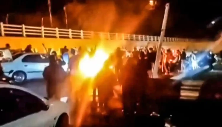 A screen grab from a video reportedly shows Iranian protesters gathered on a road leading to Evin prison on Saturday night – AFP
