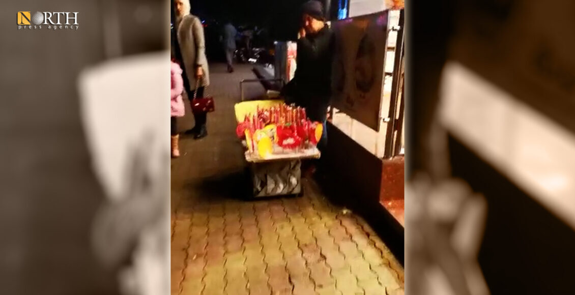 Umm Aya standing next to her cart to buy lollipops in Mezzeh in Syria's Damascus – North Press