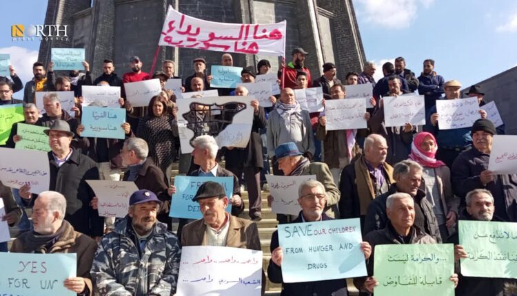 protests in front of Sultan Basha al-Attrash shrine in downtown al-Qrayya town, Sothern Suwayda