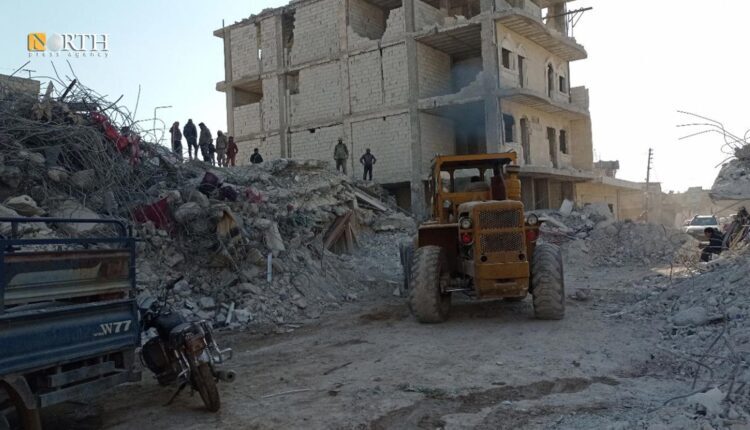 A bulldozer removing the rubble of the earthquake hit Syria and Turkey on Feb. 6 in Jindires town in northwestern Syria – North press