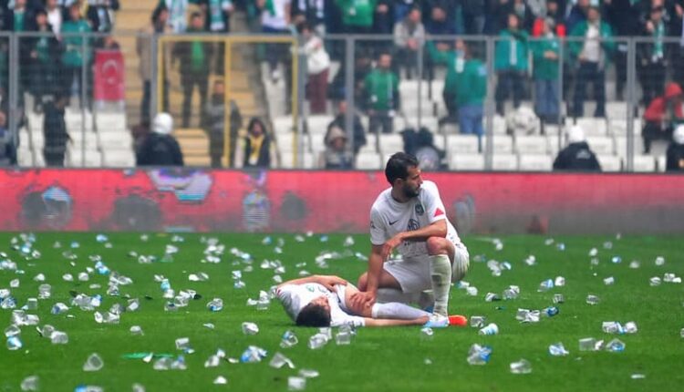 An injured player of Amedspor after being hit by fans and players of Bursaspor – AFP