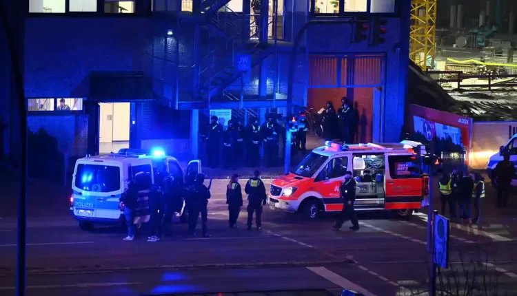 Armed police officers near the scene of a shooting in Hamburg, Germany on Thursday, March 9, 2023, after one or more people opened fire in a religious hall – AP
