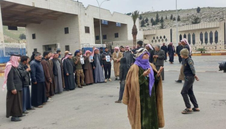 Residents protest at Bab al-Hawa border crossing with Turkey, north of Idlib in northwest Syria, against violations committed by Turkish border guards against Syrians