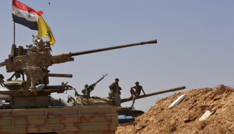 Syrian and Lebanese Hezbollah's flags in Syria – AFP