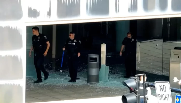 Police step on shattered glass at the Old National Bank in Louisville, Kentucky, after a mass shooting - CNN