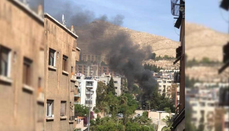 Smoke rising as a result of a car blast Barzah neighborhood in Damascus