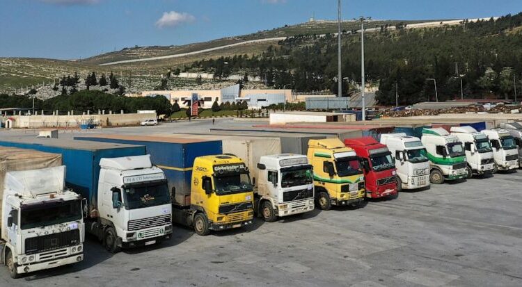 Trucks loaded with UN humanitarian aid for Syria following a devastating earthquake are parked at Bab al-Hawa border crossing with Turkey, in Syria's Idlib Governorate on Feb. 10, 2023 – Associated Press