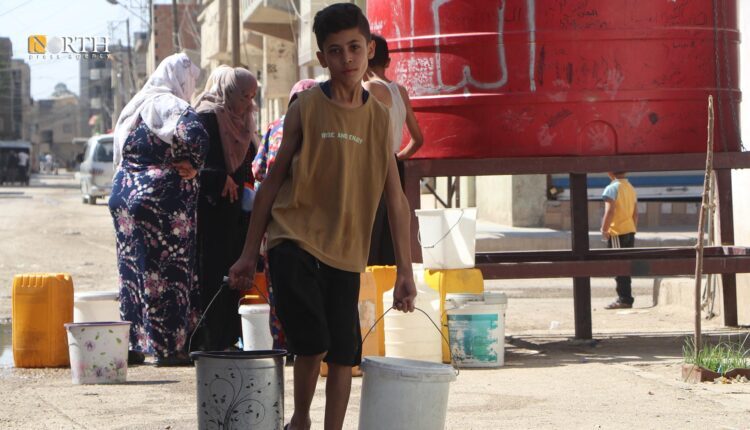 A child and residents behind striving to obtain drinking water in Guweiran in the city of Hasakah, northeast Syria – North Press