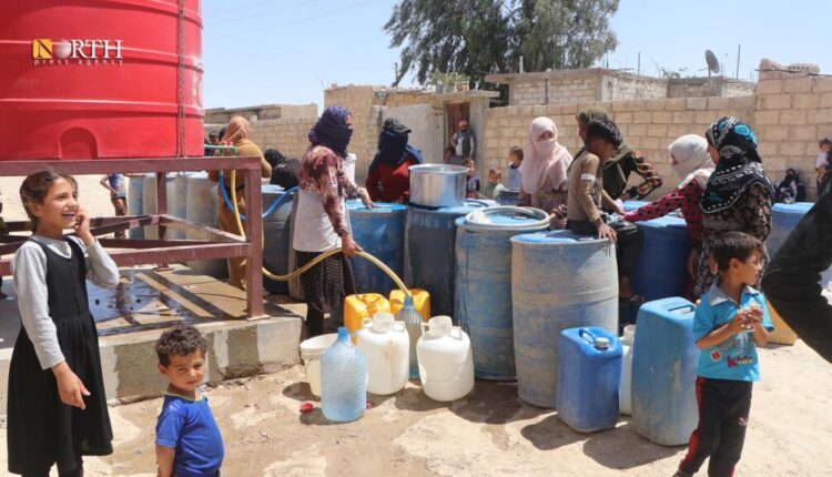 Women and children gathered to fill their gallons with water from a tank in Hasakah Governorate, northeast Syria – North Press