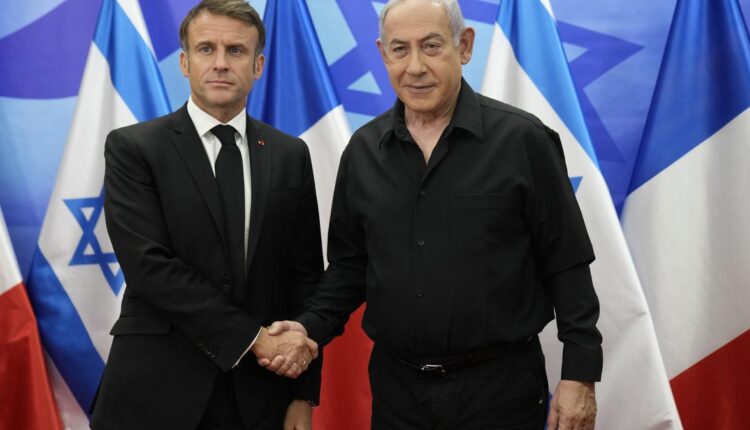 Israeli Prime Minister Benjamin Netanyahu shakes hands with French President Emmanuel Macron during a joint press conference in Jerusalem on Oct. 24, 2023 – AFP