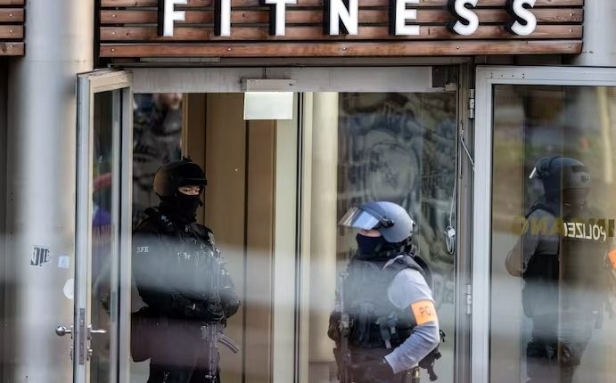 Armed police officers at the scene of a stabbing attack in a health club in Duisburg, Germany, April 18, 2023 - AP