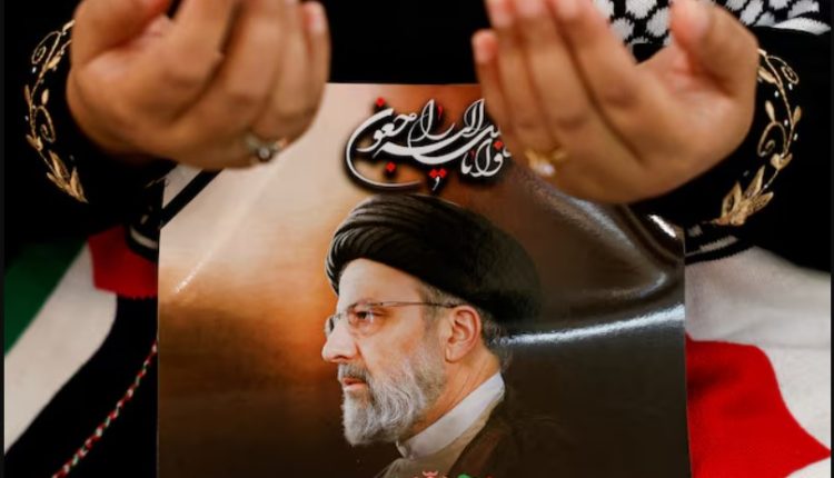 A mourner holds the picture of the late Iranian President Ebrahim Raisi, killed in a helicopter crash, at the Iranian Ambassador's residence in Jakarta, Indonesia, May 22, 2024 - REUTERS