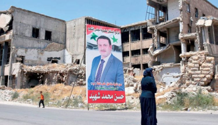 A campaign poster for the Syrian parliamentary election displayed in the northern city of Aleppo, on July 15, 2020 - AFP