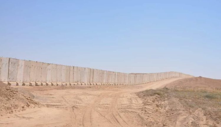 Concrete wall along the Iraq-Syria border aimed at enhancing security measures.