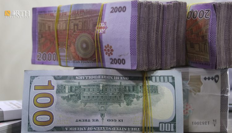 US Dollar and Syrian pound notes in Qamishli market - North Press