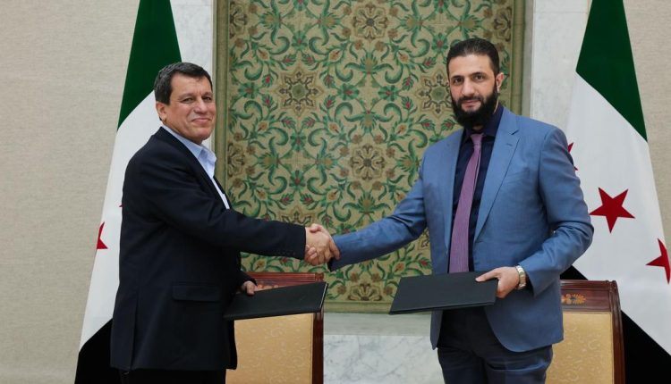 Syrian Democratic Forces (SDF) commander Mazloum Abdi and Syrian President Ahmad al-Shar’a sign an agreement in Damascus on March 10, 2025.