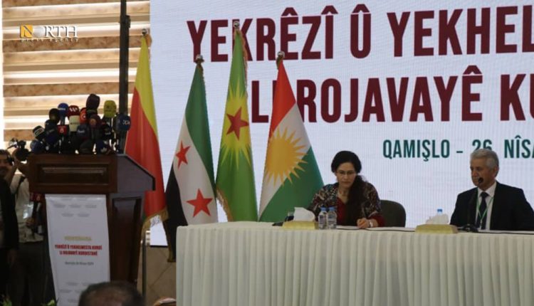 Ilham Ahmad, Co-Chair of the AANES Foreign Relations Department, and Muhammad Ismail, ENKS chair, during the opening session of the Kurdish Unity Conference in Qamishli city in NE Syria, April 26, 2025 – North Press