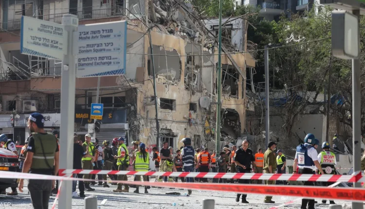 Israeli emergency services inspect the area in front of a damaged building at the site of an Iranian missile attack in Ramat Gan - AFP