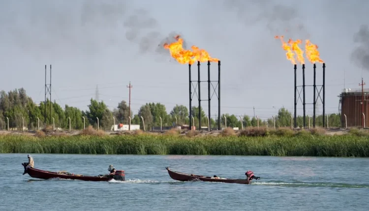 People navigate boats near Nahr Bin Umar oil field, in Basra, Iraq June 30, 2024 – Reuters