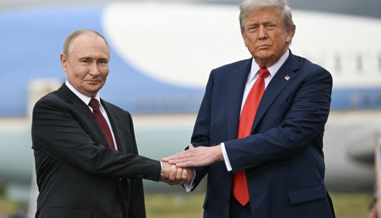 US President Donald Trump greets Russian President Vladimir Putin on the tarmac after they arrived at Joint Base Elmendorf-Richardson in Anchorage, Alaska, on Aug, 15, 2025. – AFP