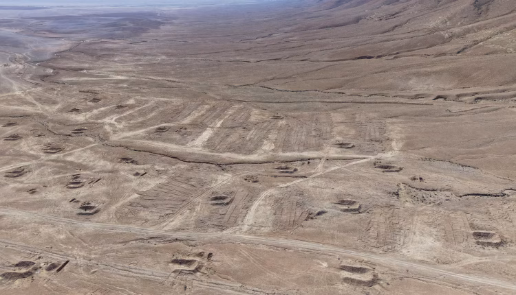 A drone view of the mass grave site in the desert near the eastern Syrian town of Dhumair, Feb. 27, 2025 – Reuters