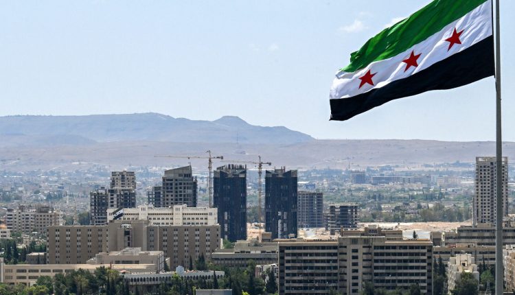 A large Syrian flag flutters above Tishrin Park in Damascus, on June 4, 2025 – AFP