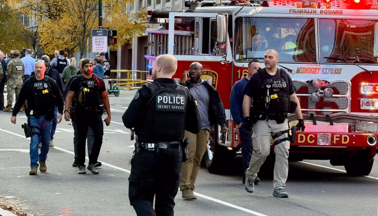 Law enforcement officers walk near a crime scene after a shooting in downtown Washington, D.C., on Nov. 26, 2025. – AFP