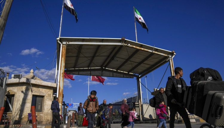 Syrians cross the border from Turkey into Syria at the Bab al-Salama crossing gate, northwestern Syria, on Dec. 13, 2024. – AP