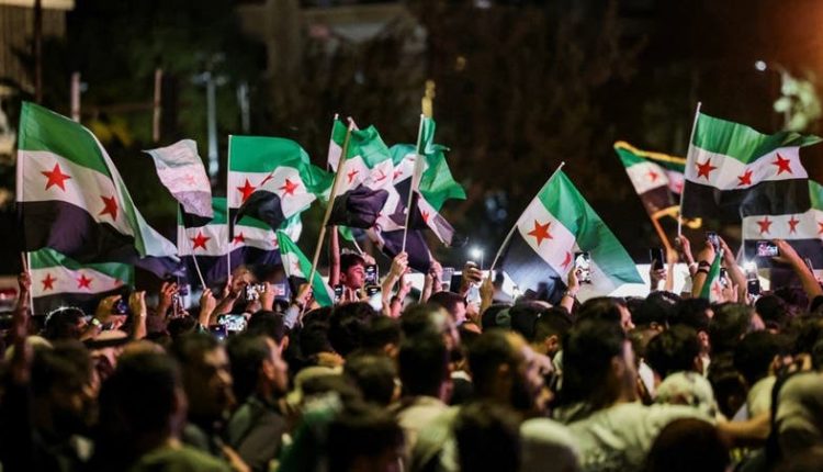 People waving Syrian flags as they gather at Umayyad Square in Damascus, Syria, Sep. 24, 2025. – Reuters