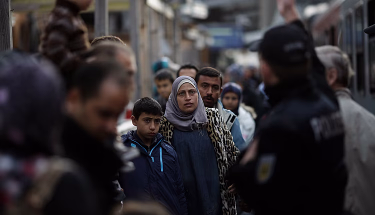 Refugees and migrants, mostly from Syria, arrive at the train station in Passau, Germany, on Sept. 16, 2015. – AP