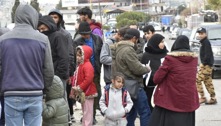 People gather at the Masnaa border crossing in Lebanon as they wait to cross into Syria – UNHCR