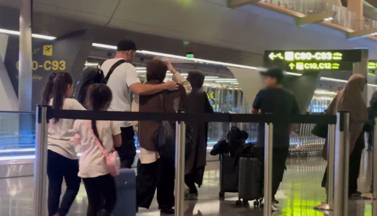 A group boarded a connecting flight from Doha