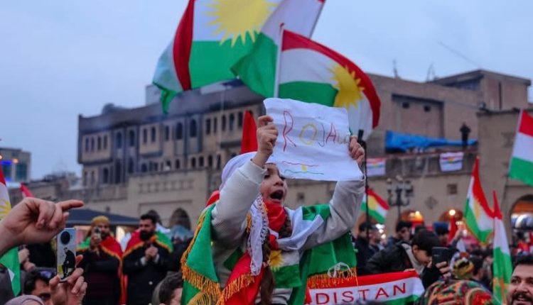 Kurds wave their flags during a gathering in Erbil, Kurdistan Region of Iraq, in solidarity with the Kurds in Syria in January 2026.