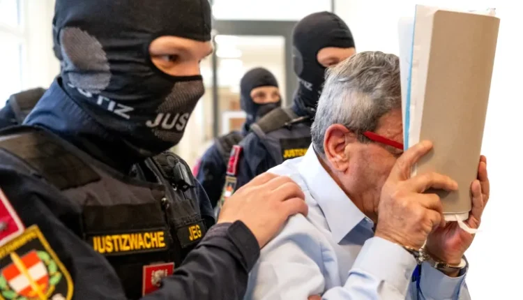Former Syrian general Khaled al-Halabi covers his face as he is escorted into court for his trial in the Austrian capital Vienna on June 1, 2026. – AFP