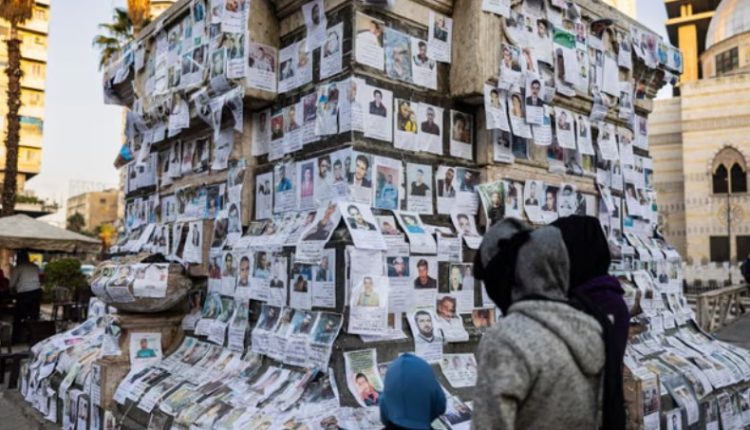 Posters of missing people hang on a monument in the center of Marjeh Square in Damascus on Dec. 26, 2024. – AFP