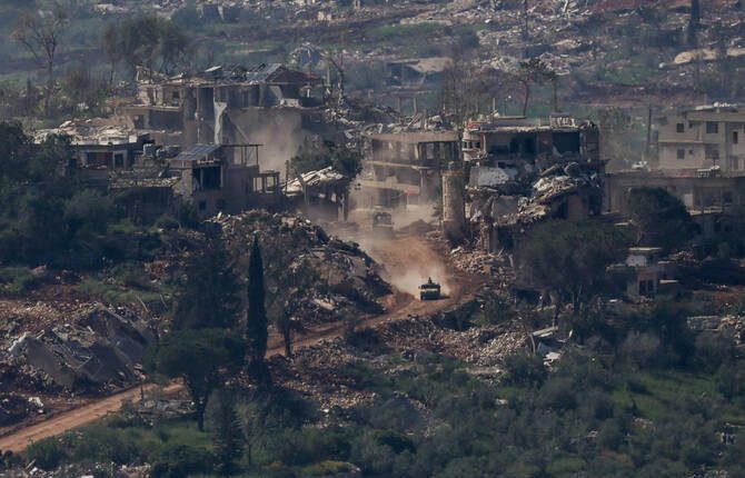 An Israeli military vehicle drives past destroyed buildings in Lebanon on April 30, 2026. – Reuters