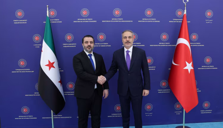 Turkish Foreign Minister Hakan Fidan shakes hands with his Syrian counterpart Asaad Hassan al-Shibani as they meet in Ankara, Turkey, August 13, 2025. - Reuters