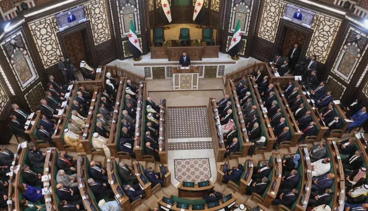 Syrian Transitional President Ahmad al-Sharaa addresses the Syrian People’s Assembly in Damascus, Syria, July 12, 2026. - AP