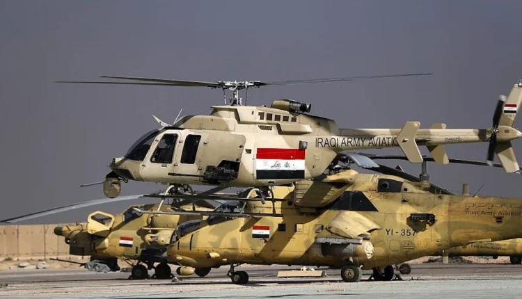 An Iraqi airforce Bell 407 helicopter takes off in front of MI-35 and MI-28 helicopters at the army base of Qaryat Jaddalat, south of the city of Mosul on Nov. 25, 2016. - AFP