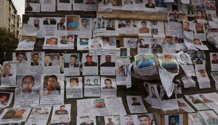 صور لأشخاص مفقودين يُعتقد أنهم سجناء من سجن صيدنايا (رويترز)