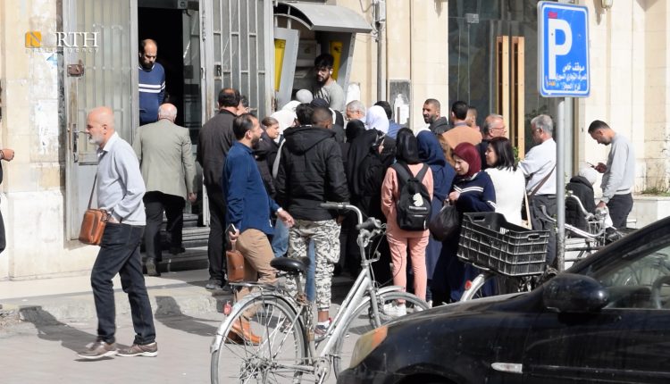 موظفون ينتظرون أمام صراف آلي في دمشق - نورث برس